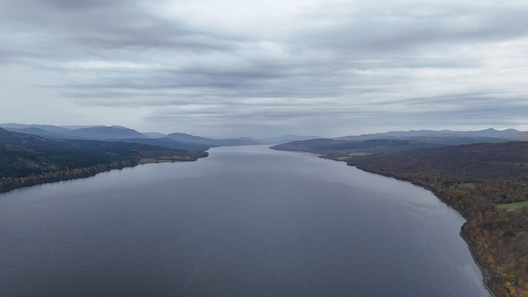 Aerial view down a Highland loch under low autumn cloud